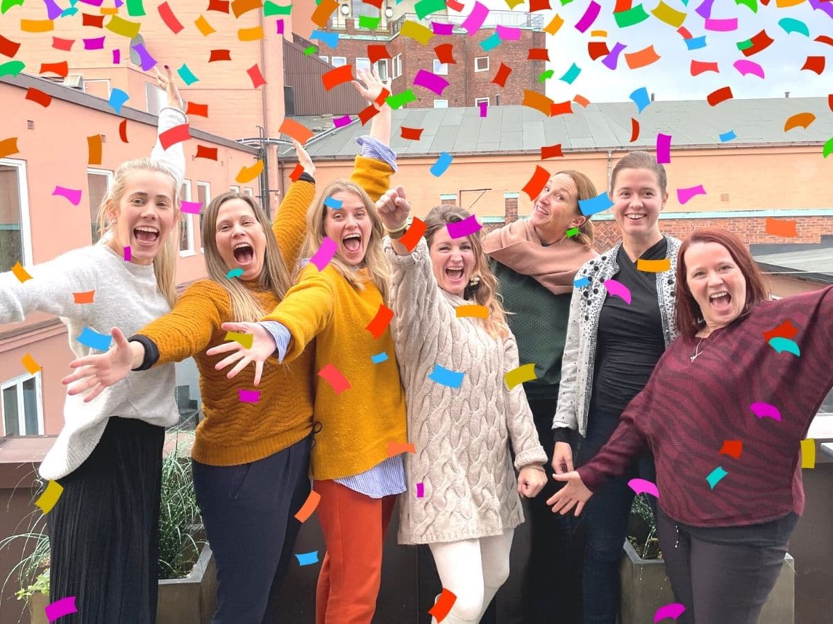 Syv damer i Endometrioseforeningens styre jubler, fargerikt konfetti faller over dem